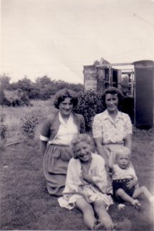 The remains of Dad's walk-in rabbit shed in the background. Me front left with brother Alan. Sister Anne behind me with our Mum, Jessica. 1954. | Nina Humphrey